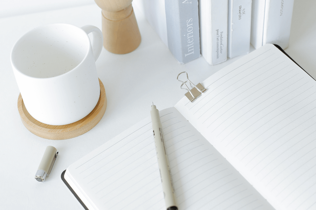 mug and blank notepad on a list